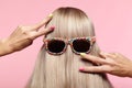 Rear view of young woman. Blond stright hair with fun sunglasses Royalty Free Stock Photo