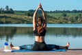 Rear view of Young woman doing exercise yoga. sitting in Sukhasana exercise, Easy Seat pose pose Royalty Free Stock Photo