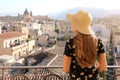 Rear view of young woman in dress and hat who looking from terrace cityscape of Palermo, Italy Royalty Free Stock Photo