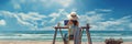 Rear view of young woman, female freelancer in straw hat working on laptop, while sitting on the tropical sandy beach Royalty Free Stock Photo