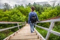 Rear view of young woman going down the long stairs. Environmental landscape stairway narrow passage from above to down between Royalty Free Stock Photo