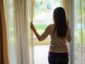 Sad Woman looking out a window, indoors. Royalty Free Stock Photo