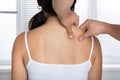 Young Woman Receiving Shoulder Massage Royalty Free Stock Photo