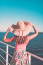 Cruise ship vacation woman enjoying travel vacation at sea. Free carefree happy girl looking at ocean and holding sunhat Royalty Free Stock Photo