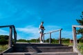 Rear view of a young woman in short shorts climbing stairs in a summer park on a sunny day Royalty Free Stock Photo