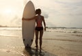 Rear view of young woman surfer with surfboard Royalty Free Stock Photo