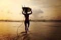 Woman surfer with white surfboard walking to the sea Royalty Free Stock Photo