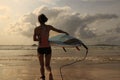 Woman surfer with white surfboard walking to the sea Royalty Free Stock Photo