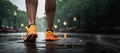 Rear view of young woman walking, exercising and running on the street in the park on an autumn morning.