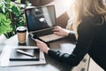 Rear view. Young woman is working on laptop with inscription on screen e-learning and image of square academic cap. Royalty Free Stock Photo