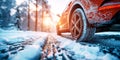 rear wheel of a car on a snowy road in winter close up. Red car rides on a highway in nature with snow Royalty Free Stock Photo
