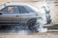 Rear wheel drive sport car burning tire for warm up before competition start. Royalty Free Stock Photo