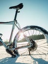 Rear  wheel of fat bike on a winter trail against sun and blue sky Royalty Free Stock Photo