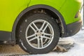Rear wheel of green Volkswagen ID.4 electric car..