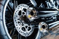 Rear wheel of a harley davidson motorcycle. View of the brake disc and exhaust pipes. Close-up Royalty Free Stock Photo