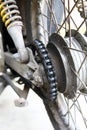 The Rear Wheel of a Motorcycle with a Dirty Chain Royalty Free Stock Photo