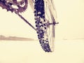 Rear wheel of mountain bicycle in snowy meadow in countryside. Detail of bike Royalty Free Stock Photo