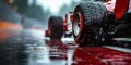 rear wheel of red Formula one racing car at start of race in rain on wet slippery asphalt Royalty Free Stock Photo