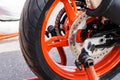 Rear wheel of a red motorcycle. Fragment of a tire and brake disc. Close-up