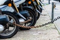 The rear wheels of the pizza delivery scooter chain are locked with an anti-theft chain Royalty Free Stock Photo