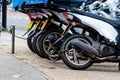 The rear wheels of the pizza delivery scooter chain are locked with an anti-theft chain Royalty Free Stock Photo