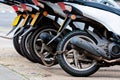 The rear wheels of the pizza delivery scooter chain are locked with an anti-theft chain Royalty Free Stock Photo