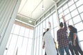 Rear wide view of multiethnic diverse creative asian group huddle and high five together in office workshop with success or Royalty Free Stock Photo