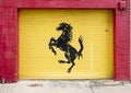 Rearing black horse painted on a rolling yellow door in Deep Ellum in East Dallas, Texas.