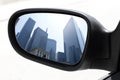 Rearview car driving mirror view city downtown