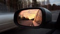 Rearview car driving mirror view forest road Royalty Free Stock Photo