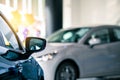 Rearview car parked in luxury showroom. Car dealership office. New car parked in modern showroom. Car for sale and rent business Royalty Free Stock Photo