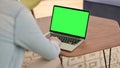 RearView of Man Workingon Laptop with Chroma Screen