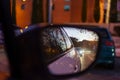 Rearview mirror of a car at night that reflects the lights of other vehicles circulating on the street. Royalty Free Stock Photo