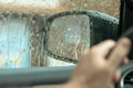 Rearview mirror in a car during rain. Blurry raindrops and reflection of lights in the mirror Royalty Free Stock Photo