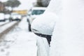 Rearview mirror covered with snow.