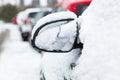 Rearview mirror covered with snow.