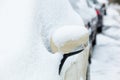 Rearview mirror covered with snow.