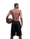 Looking for the competition. Rearview shot of a basketball player standing shirtless in the studio.