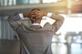 Business comes with its own unique pressure. Rearview shot of a businessman standing with his hands behind his head. Royalty Free Stock Photo