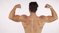 Rearview shot of a muscular shirtless man flexing his back and arms muscles Royalty Free Stock Photo