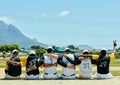 First baseball, then peace. Rearview shot of a team of unrecognizable baseball players embracing each other while