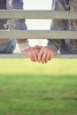 Always hand in hand. Rearview shot of a young gay couple sitting together on a park bench. Royalty Free Stock Photo