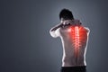 Dont take risks with a back injury. Rearview shot of a young man in the studio with cgi highlighting his back injury.