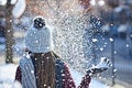 She turns snow into glitter. Rearview shot of a young woman throwing snow on a wintery day outdoors. Royalty Free Stock Photo