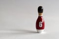 rearview of a wooden puppet in the shape of a bowling pin with a number six shirt Royalty Free Stock Photo