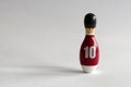 rearview of a wooden puppet in the shape of a bowling pin with a number ten shirt Royalty Free Stock Photo