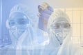The reasearcher,scientist,doctor,or chemist in virus protective suit  with hand using syringes vacuuming vaccine in  lab Royalty Free Stock Photo