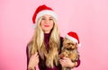Reasons to love christmas with pets. Ways to have merry christmas with pets. Girl attractive blonde hold dog pet pink