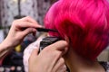 Reative haircut with clipper, model with pink hair