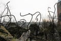 The rebar sticking up from piles of brick rubble, stone and concrete rubble against the sky in a haze - Remains of the destroyed